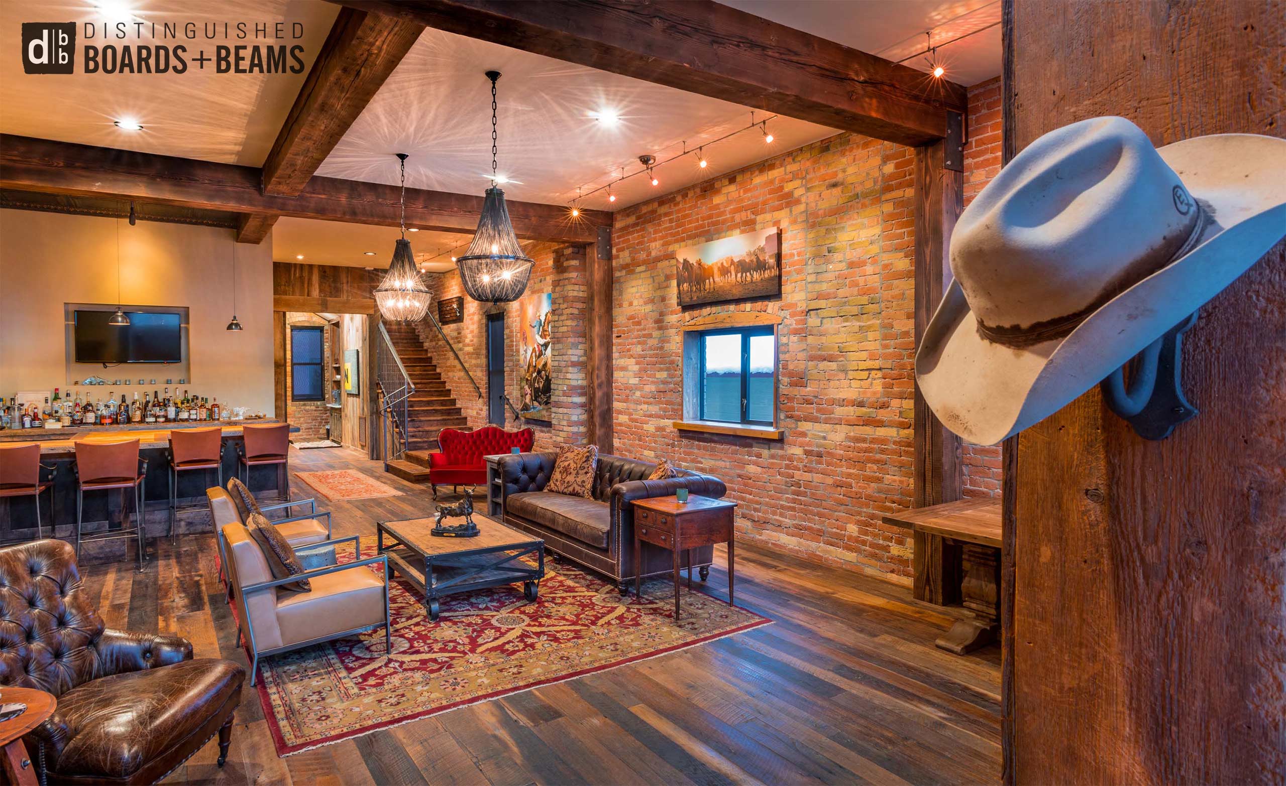 Classic look rough sawn Reclaimed barn wood timbers with mixed hardwood flooring for a rustic western themed living room